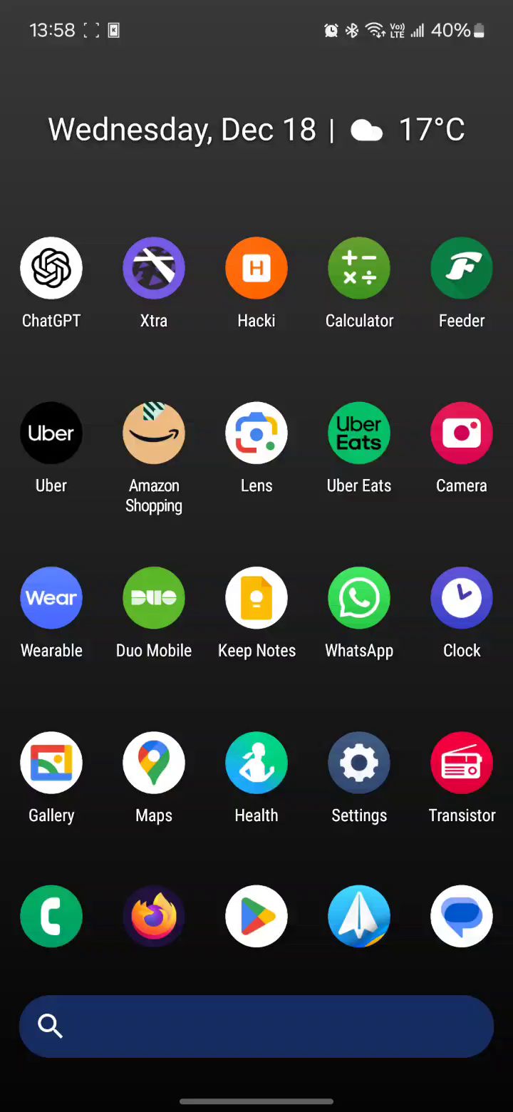 Another newer but poor quality screenshot of Nova Launcher's home screen, which contains circular app icons, as well as a search bar at the bottom. It also displays a simpler Google widget, which mentions the date being 18th of December as well as weather temperature being at 17℃. The weekday displayed is Wednesday.